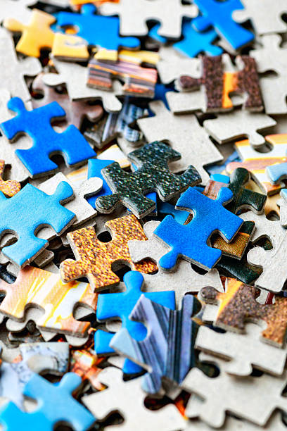 istock Jigsaw puzzle pieces.Colorful background with small puzzle pieces, messy.Some colored pieces of puzzle as background.Challenge and solution concept. Hobbies and leisure activities 2249204932