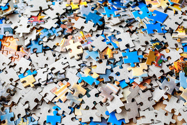 istock Jigsaw puzzle pieces.Colorful background with small puzzle pieces, messy.Some colored pieces of puzzle as background.Challenge and solution concept. Hobbies and leisure activities 2249204948