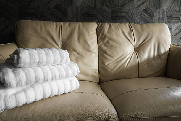 Two folded bathrobes on bed in room