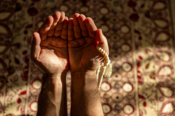 istock close up of man praying at home 2249208522