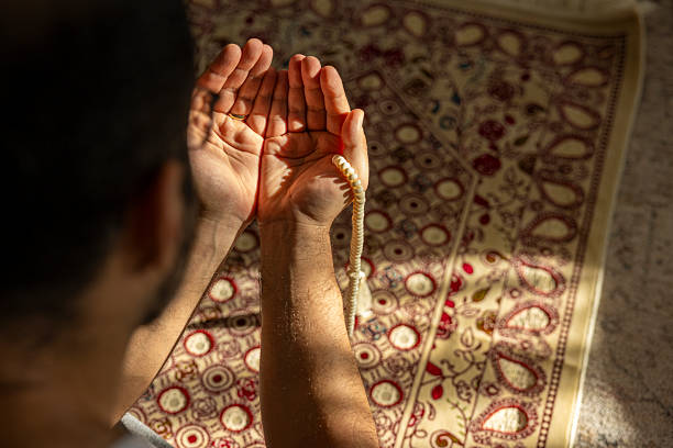 istock close up of man praying at home 2249208550