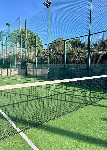 istock Padel Court Net and Bright Green Surface Under Blue Sky 2249208655