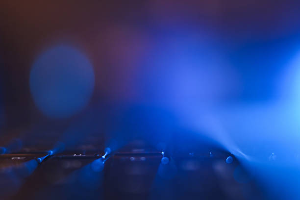 Guitar strings reflecting neon blue light emphasizing music and abstract art