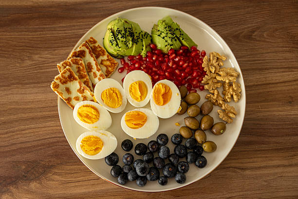 Plate with healthy salad of olives cabbage tomatoes and cheese