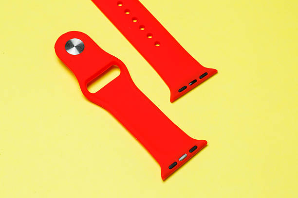 istock silikone strap for smart watch red color on yelow background 2249213211