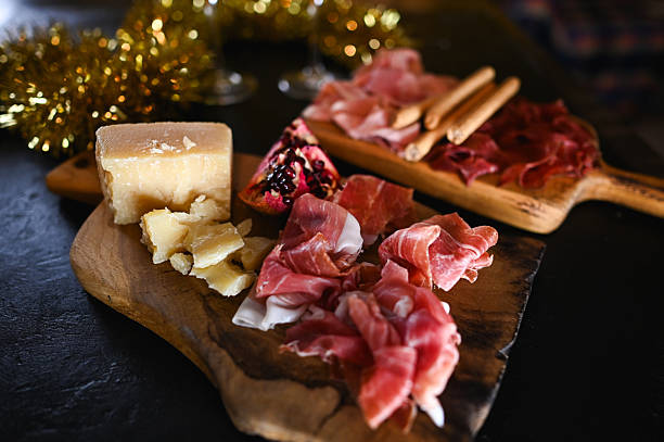 istock Charcuterie board with prosciutto, cheese, and pomegranate seeds 2249215930