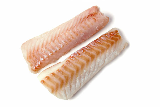 istock Two frozen fish fillets isolated on white background. 2249216391