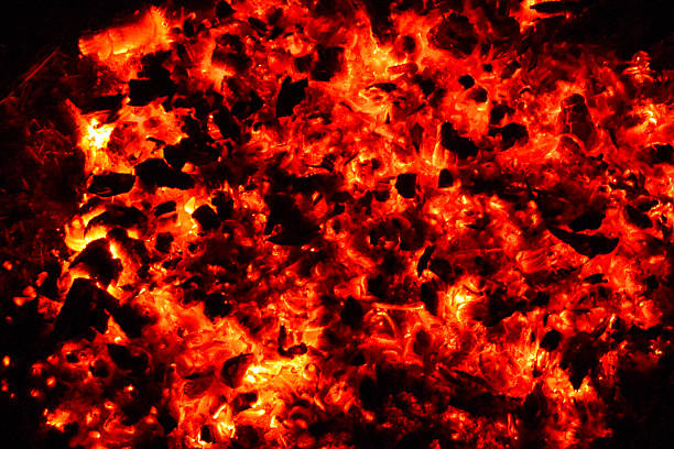 istock hot glowing coals shine brightly in the dark 2249217300