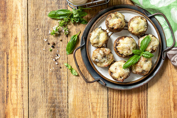 istock Stuffed mushrooms baked with cheese on rustic background. Top view. 2249218327