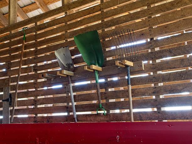 Farm work tools hanging on wooden rack on side of barn, at Carter Historical Farm, Bowling Green Ohio.