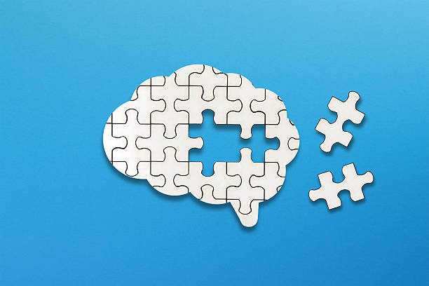 istock Brain shaped white jigsaw puzzle on blue background. Mental health and problems with memory. 2249219773
