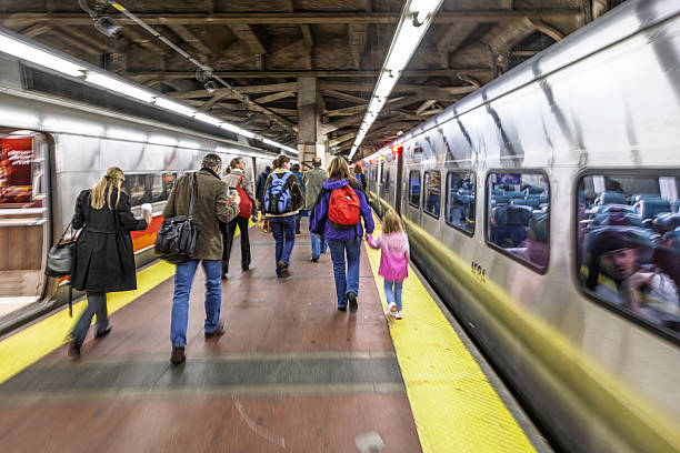 People exit a Connecticut train at Grand Central Terminal in NYC, heading towards the station exit during a bustling morning commute.