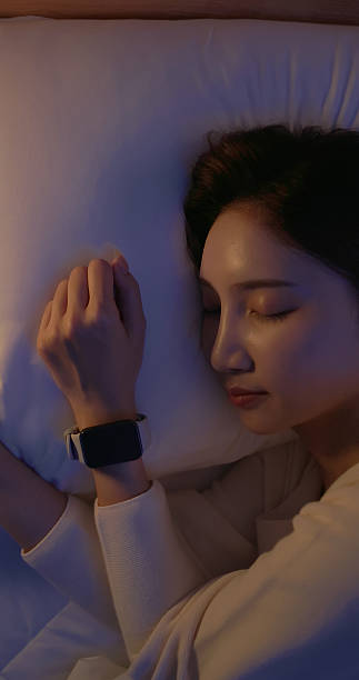 istock asian woman sleep with smartwatch 2249220639