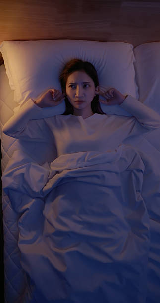istock asian woman sleepless due to noise night 2249220762