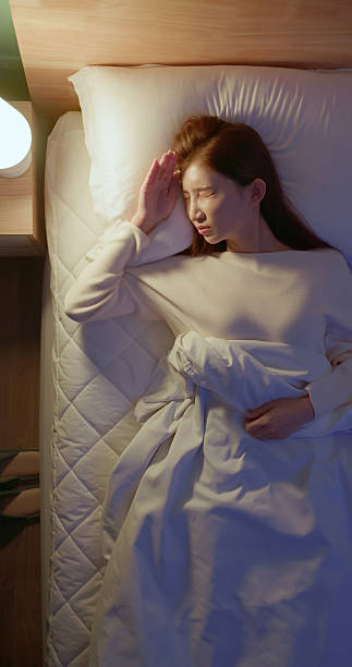 istock asian woman too bright light sleepless night 2249220843