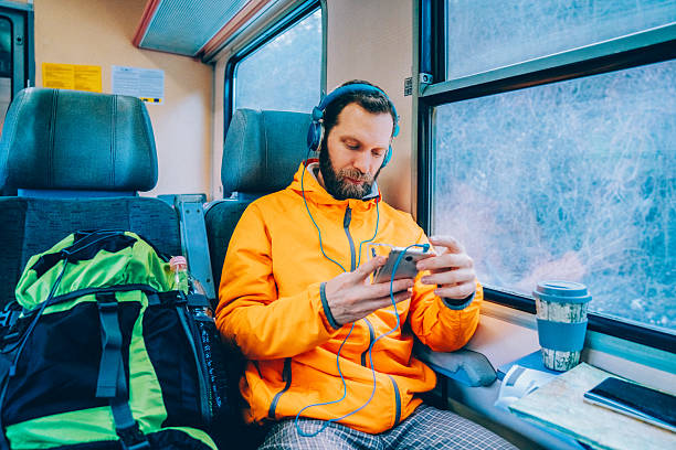 istock Male backpacker traveling by train and using smartphone during winter journey 2249221650
