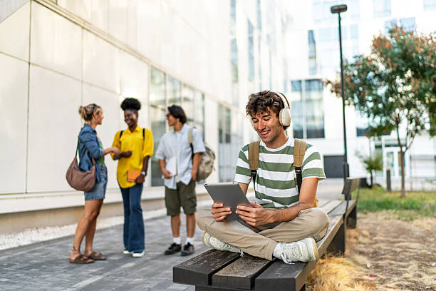 istock Young student listening to music and studying on campus 2249222908