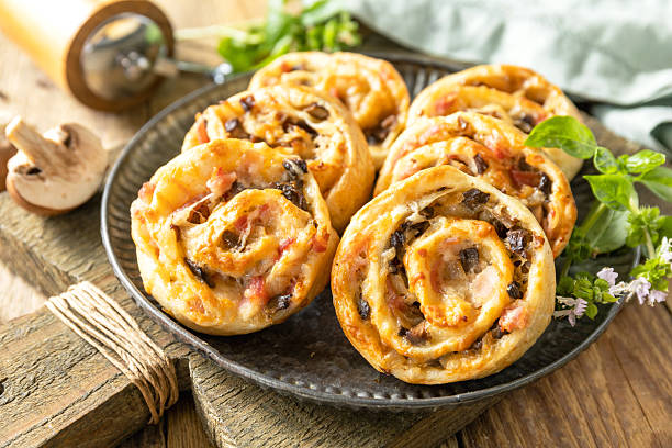 istock Puff pastry rolls with mushroom and cheese filling on rustic background. 2249223049