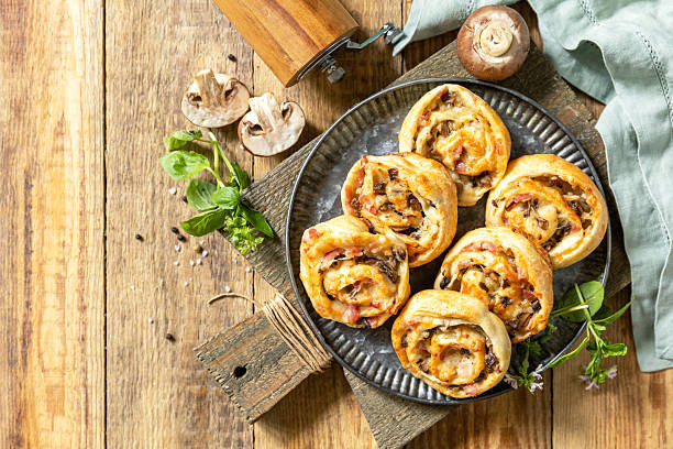 istock Puff pastry rolls with mushroom and cheese filling on rustic background. Top view. 2249223072