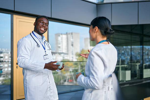 istock Diverse doctors talking during coffee break at hospital 2249223317