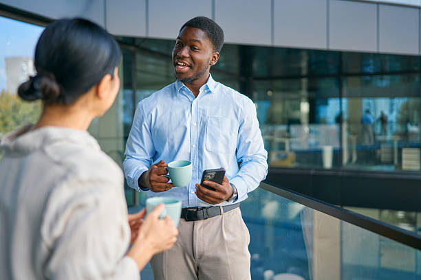istock Diverse business colleagues having coffee break conversation outdoors 2249223435