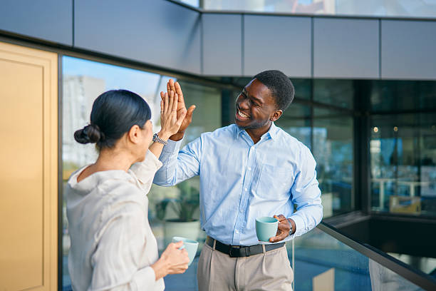 istock Diverse business colleagues celebrating success with high five 2249223437