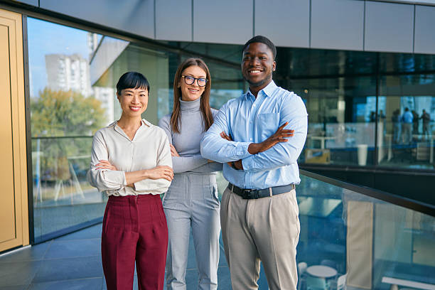 istock Diverse business team smiling standing with arms crossed 2249223439