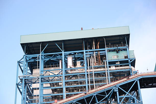 Complex blue steel structure of industrial plant under a clear, bright and sunny sky.