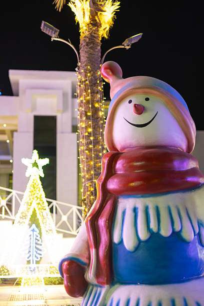 istock Snowman statue with festive lights at night 2249228961