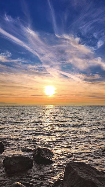 istock Golden-Hued Sunset Reflecting on Gentle Ocean Waves. Vertical Video. 2249229299