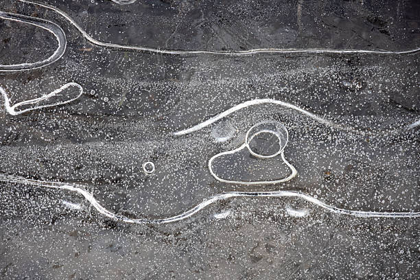 Frozen stream and ice closeup photo. Beautiful winter abstract background in nature. Concept for water and winter time