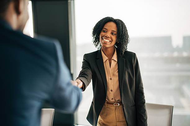 istock Businesswoman shaking hands making professional agreement in office 2249232471