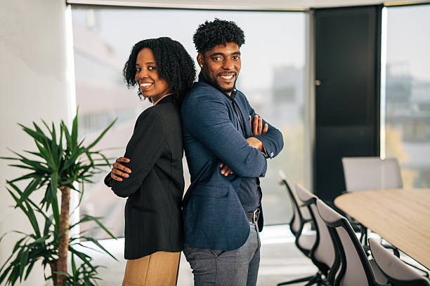 istock Business partners standing back to back in office 2249232642