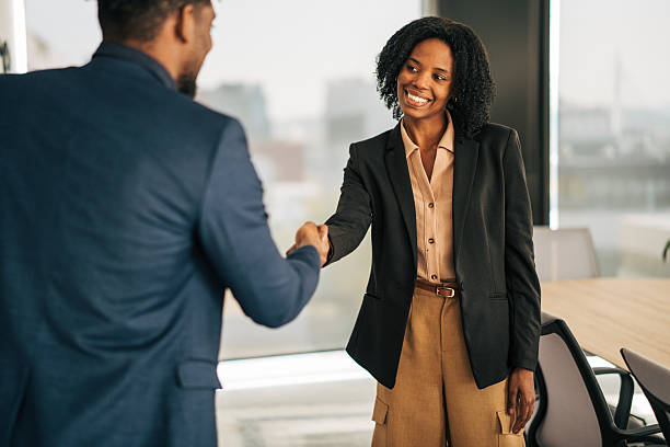 istock Businesswoman shaking hands with client in office 2249232691