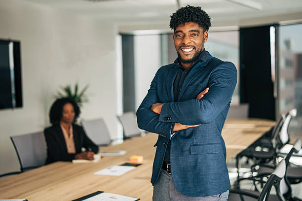 istock Confident businessman smiling in modern office meeting room 2249232709