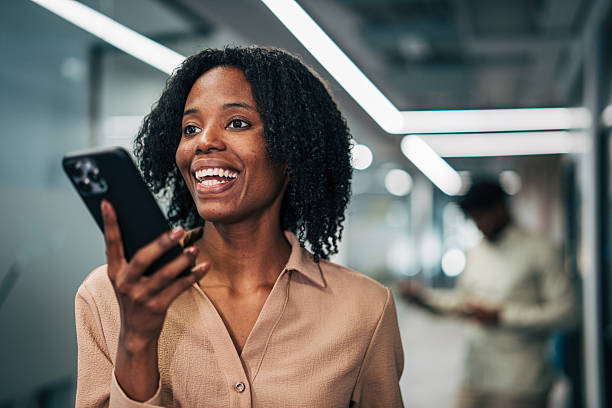 istock Happy businesswoman using smartphone in modern corporate office 2249232746