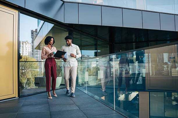 istock Business colleagues discussing project while walking outdoors 2249232933