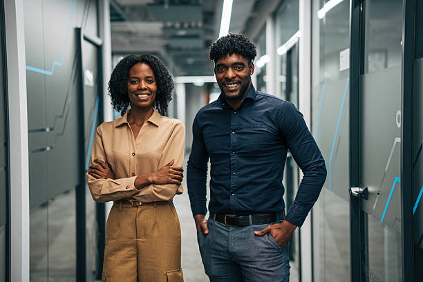 istock Diverse business professionals smiling in modern office corridor 2249234152