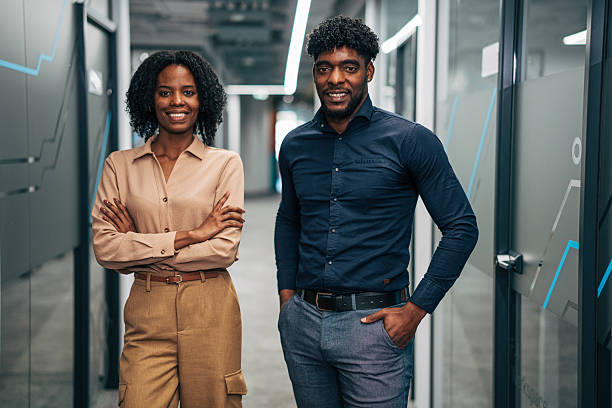 istock Diverse business people smiling in modern office hallway 2249234220