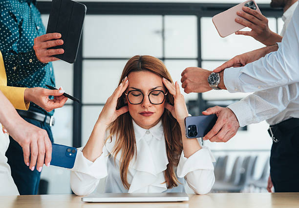 istock Overwhelmed Businesswoman in a Busy Environment 2249234653