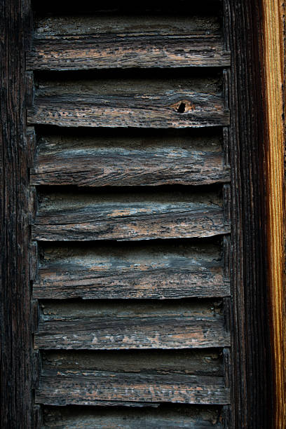 istock Weathered Wooden Shutters with Rustic Texture and Golden Grain Detail 2249237392