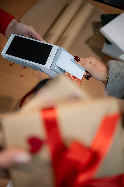 istock Customer making contactless payment for gifts during shopping 2249238929