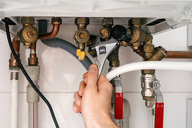 istock Repairman working on modern boiler in utility room for maintenance 2249239826