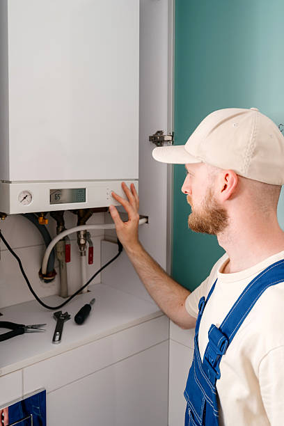istock Repairman checking gas boiler in bathroom for efficient maintenance 2249239827