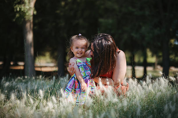 istock Carefree young mother and daughter hugging in spring day. 2249240109