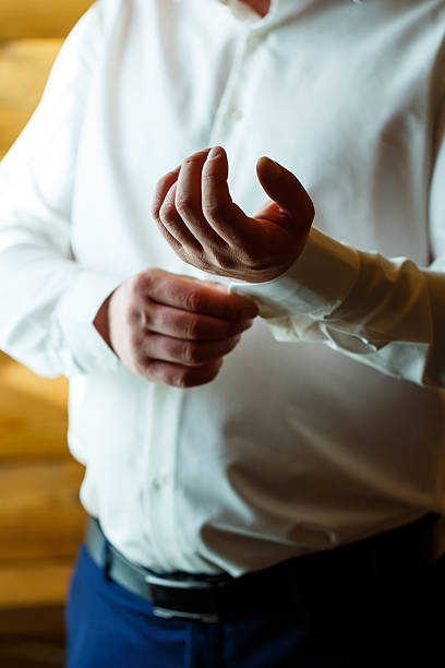 istock Man puts on a wedding suit and accessories on the wedding day. 2249242355