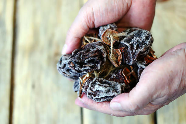 istock Close-up of hands holding dried persimmons, or hoshigaki. 2249242737
