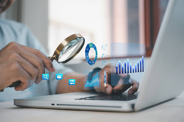 istock businessman holding magnifying glass looking at virtual data chart dashboard in concept of investment data analysis and DMS document audit financial Using Magnifying Glass 2249245861