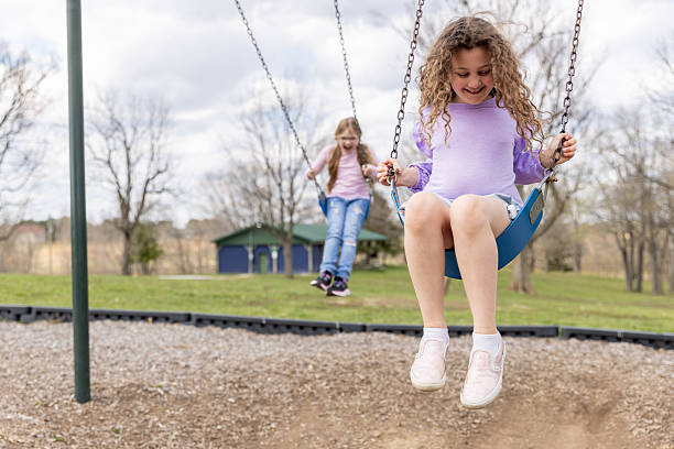 istock Children with Type 1 diabetes play on swing set at public park 2249247616