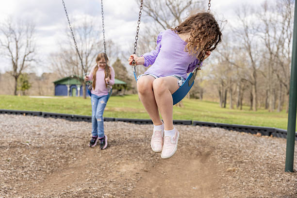 istock Child with Type 1 diabetes wears continuous glucose monitor while playing on swing 2249247618